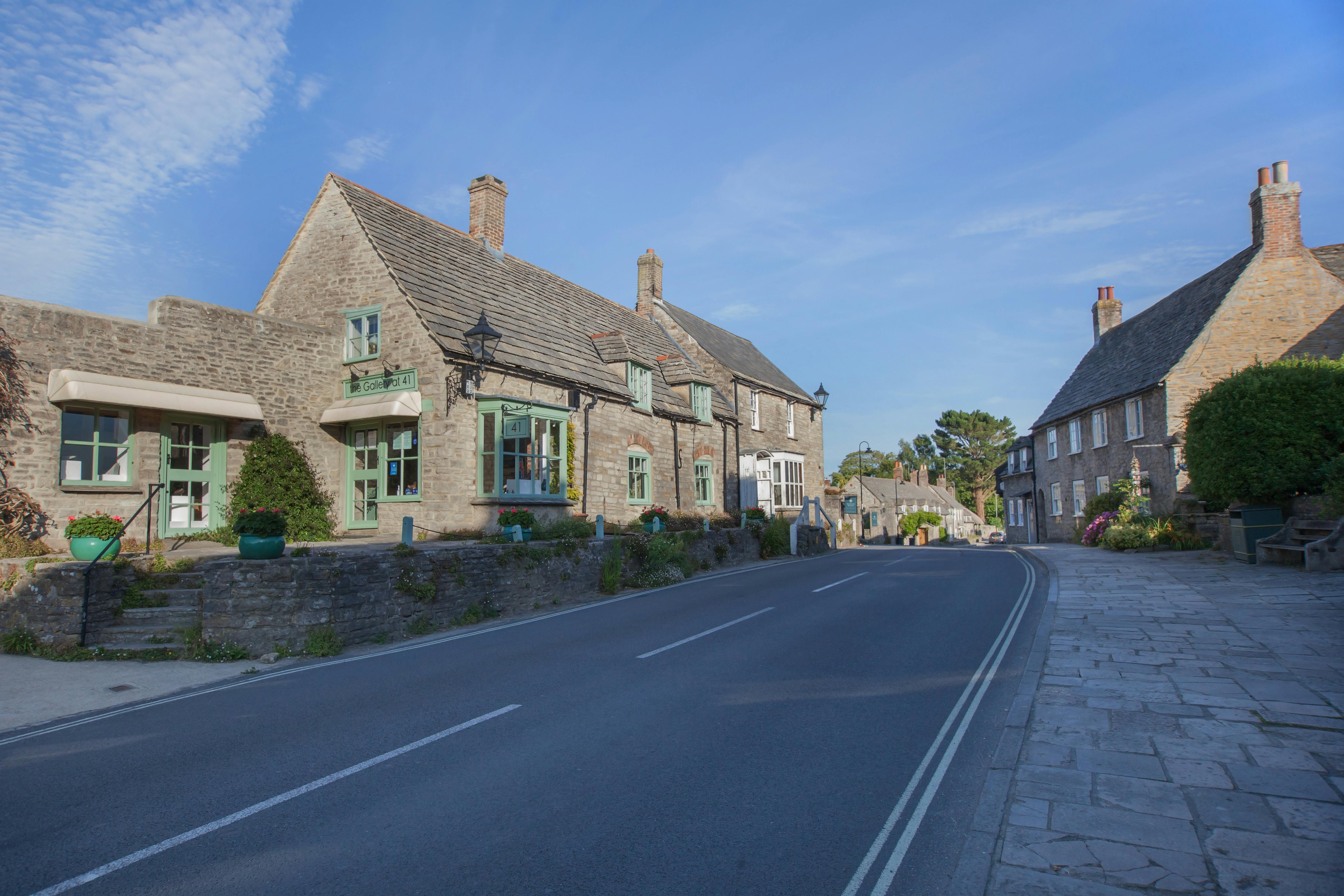 A village street with historic stone buildings in Dorset, England